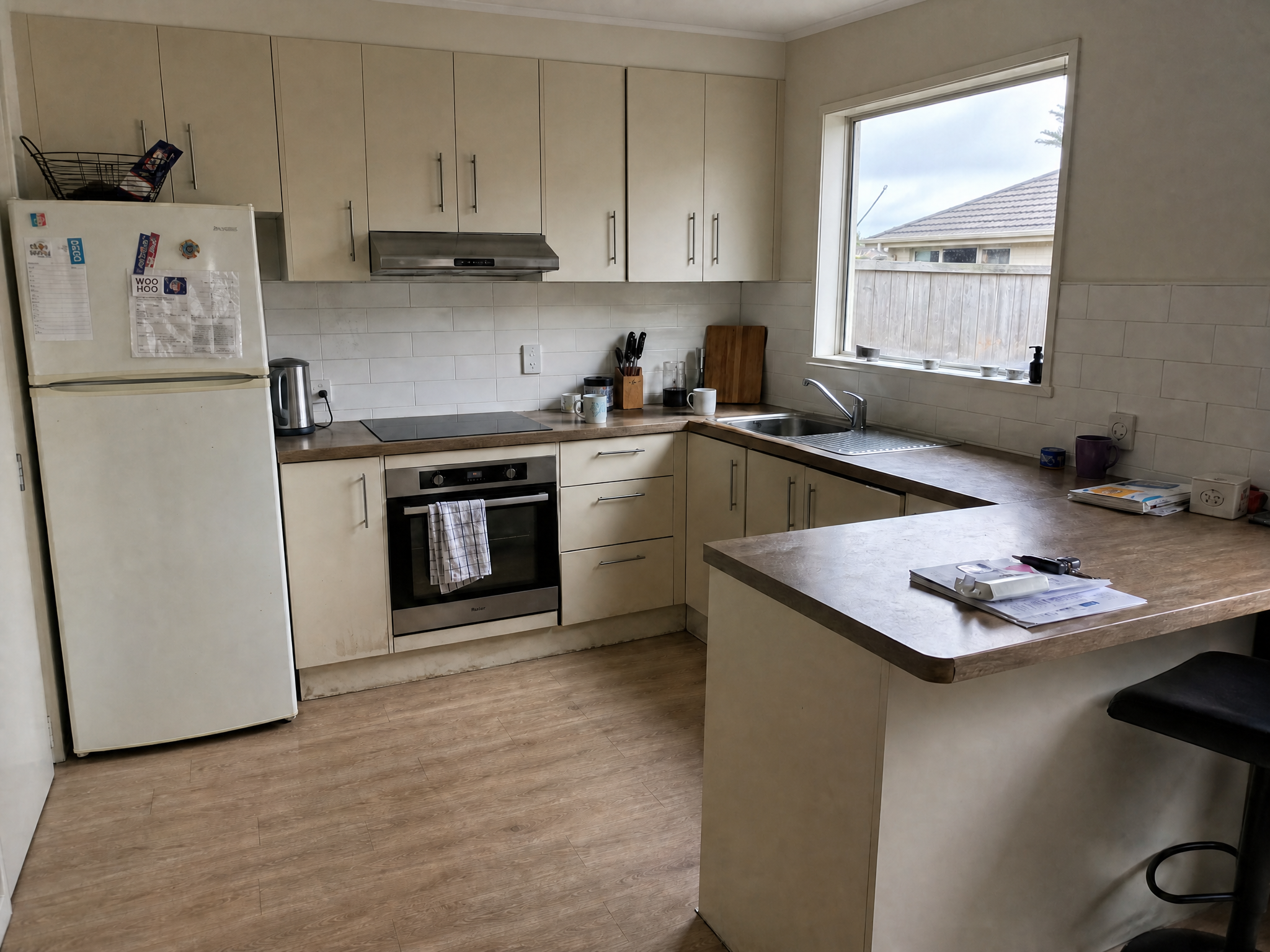 Kitchen before 2-hour joinery session — cluttered benchtops, dated look