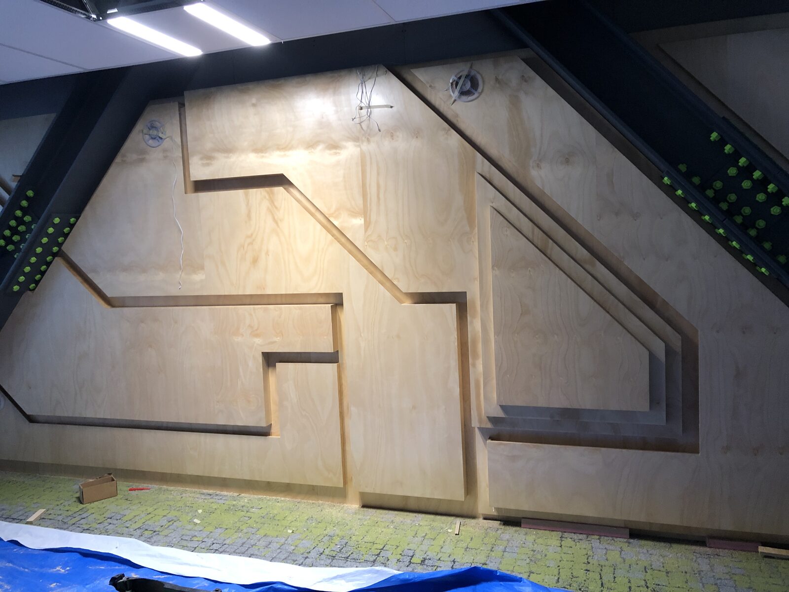 Custom plywood feature wall — geometric design for Hamilton retail fitout