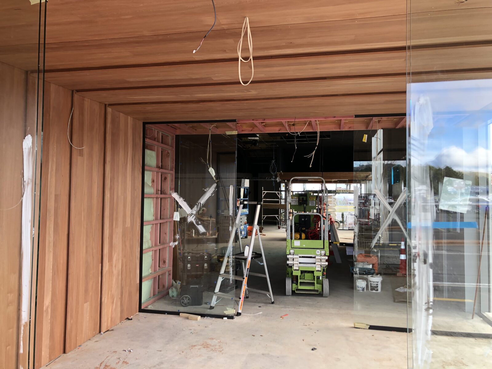 Rotorua Airport arrivals — cedar wall lining and glass entrance during construction